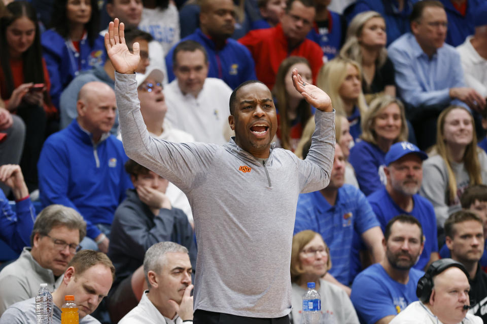 Oklahoma State head coach Mike Boynton Jr. reacts during the first half of an NCAA college basketball game against Kansas, Tuesday, Jan. 30, 2024, in Lawrence, Kan. (AP Photo/Colin E. Braley)