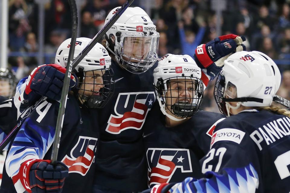 United States' Megan Keller (5) celebrates her goal with Dani Cameranesi (24), Emily Matheson (8) and Annie Pankowski (27) during the first period of a rivalry series women's hockey game against Canada in Hartford, Conn., Saturday, Dec. 14, 2019. (AP Photo/Michael Dwyer)