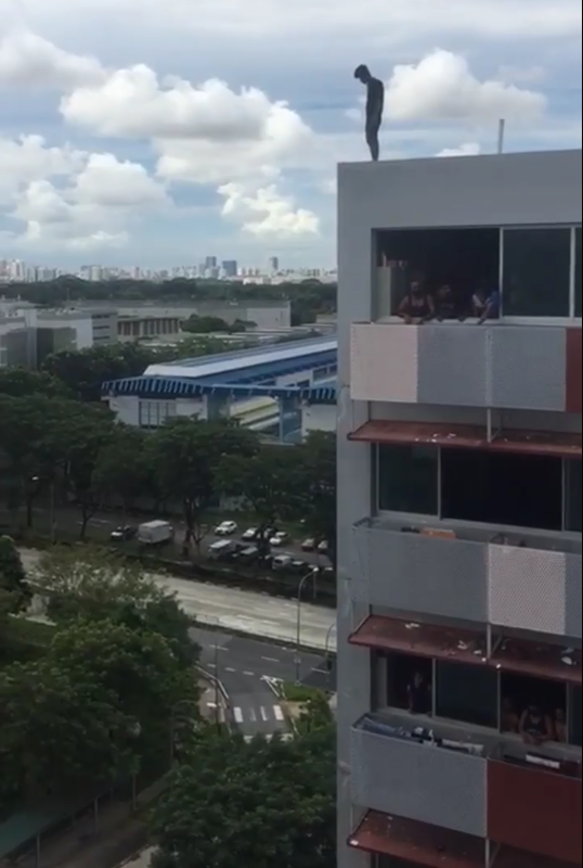 A 19-year-old migrant worker perched atop a block at Sungei Tengah Lodge, who was later apprehended under the Mental Health Act. SCREENCAP: Singapore to Bangladesh Facebook page