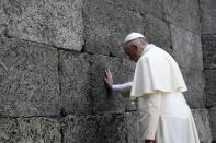 Pope Francis prays in front of the death wall at the former Nazi concentration camp of Auschwitz in Oswiecim, Poland, Friday, July 29, 2016. Pope Francis paid a somber visit to the Nazi German death camp of Auschwitz-Birkenau Friday, becoming the third consecutive pontiff to make the pilgrimage to the place where Adolf Hitler’s forces killed more than 1 million people, most of them Jews. (L'Osservatore Romano /Pool Photo via AP)
