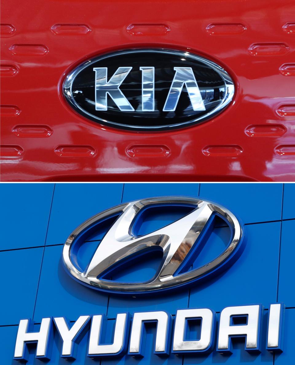 This combination of file photos shows the Kia Motors logo, top and the Hyundai logo, bottom.