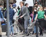 <p>Adam Driver rides a bike while filming <em>The Gucci House</em> on Thursday in Rome.</p>