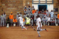 Kenyan prisoners watch a mock world cup soccer match between Russia and Saudi Arabia, as part of a month-long soccer tournament involving eight prison teams at the Kamiti Maximum Prison, Kenya's largest prison facility, near Nairobi, Kenya, June 14, 2018. REUTERS/Baz Ratner