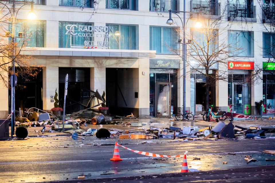 Debris lay on the street after a huge fish tank burst at the Seal Life Aquarium in central Berlin, Germany, Friday, Dec. 16, 2022. (Christoph Soeder/dpa via AP)