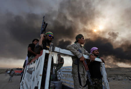 Iraqi pro-government forces are seen in Qayyara. REUTERS/Alaa Al-Marjani