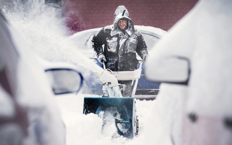 A man pushes a snow blower in Toronto as the cold grip of winter continues in Ontario. Elsewhere, a potentially serious winter storm is forecasted to hit parts of Atlantic Canada on Thursday. Photo from Bernard Weil/Toronto Star via Getty Images.