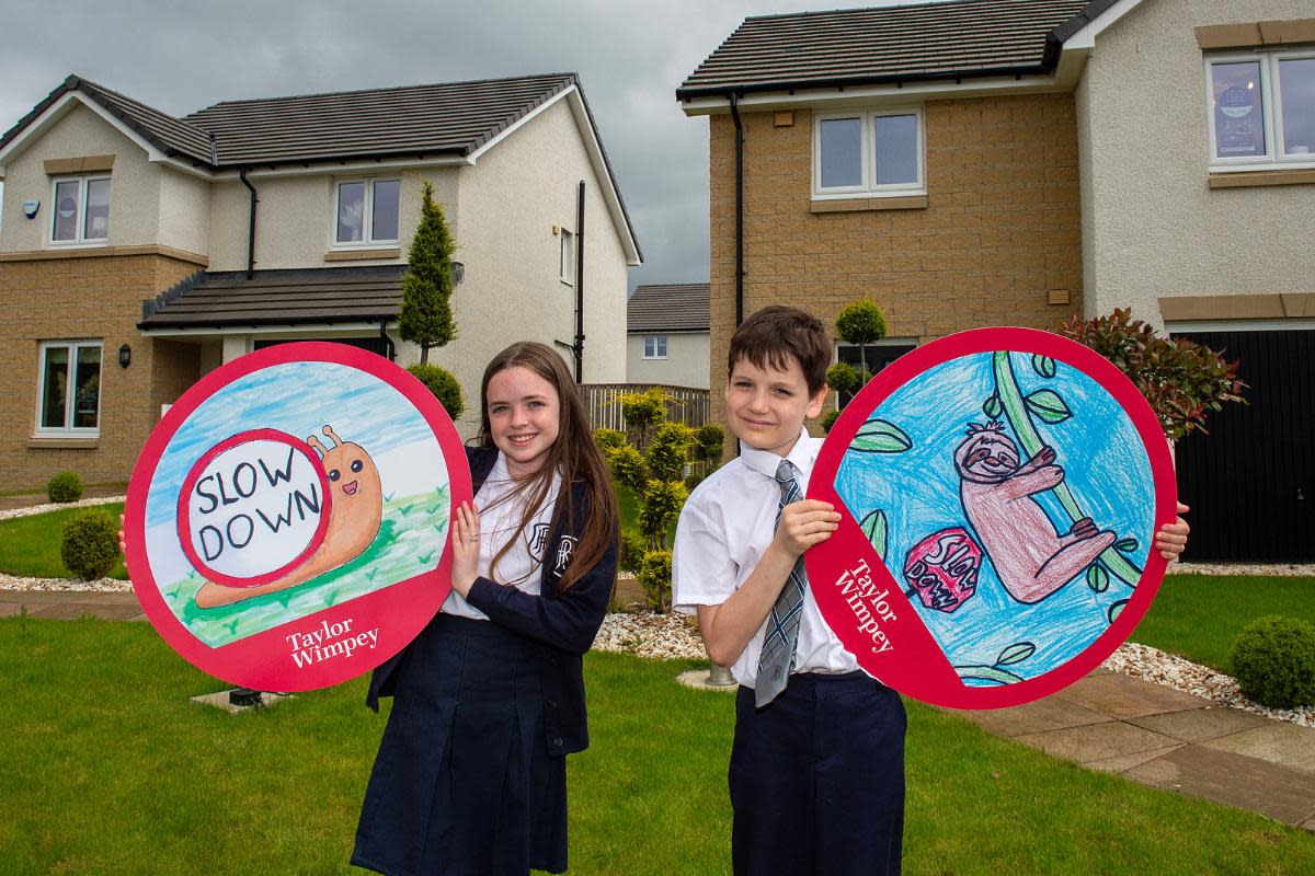 Hannah Summers, 11, and Flynn Thomson, 10, from Holytown Primary School, created the winning designs aimed at encouraging drivers to drive safely through Taylor Wimpey West Scotland's development in Holytown <i>(Image: Taylor Wimpey West Scotland)</i>