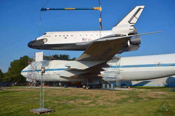 Space Center Houston's replica space shuttle Independence is lowered by crane on top of NASA's historic Shuttle Carrier Aircraft on Aug. 14, 2014. <a href="http://www.collectspace.com/news/news-081414b-rise-of-independence-shuttle.html" rel="nofollow noopener" target="_blank" data-ylk="slk:Click h;elm:context_link;itc:0;sec:content-canvas" class="link ">Click h</a>