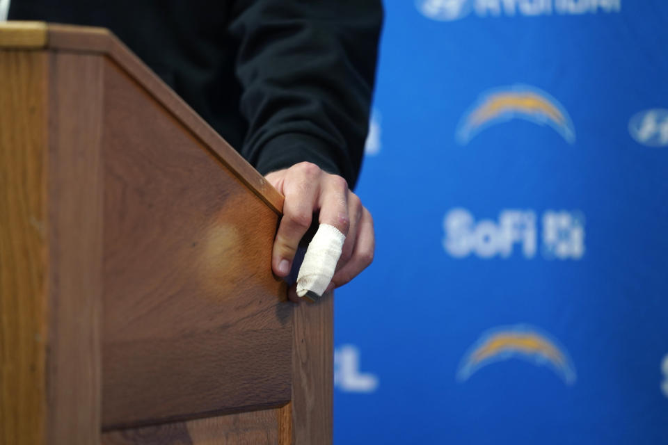 Los Angeles Chargers quarterback Justin Herbert speaks during a news conference as his injured finger is seen following an NFL football game against the Kansas City Chiefs Sunday, Oct. 22, 2023, in Kansas City, Mo. The Chiefs won 31-17. (AP Photo/Ed Zurga)