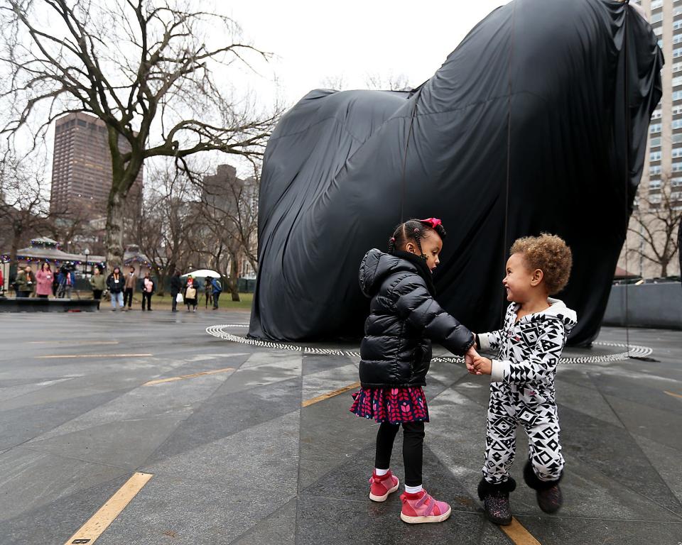 Zenzele Thomas, 4, of New York plays Friday with her cousin, Mahala Gave, 2½, of Brooklyn, N.Y., underneath "The Embrace," which Zenzele's father, Hank Willis Thomas, created.