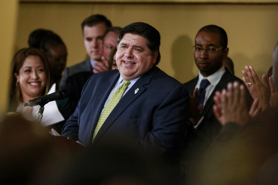 Gov. J. B. Pritzker takes in the applause before signing a bill Tuesday, June 25, 2019 that legalizes adult-use cannabis in the state of Illinois at Sankofa Cultural Arts and Business Center in Chicago. Illinois becomes the 11th to legalize the adult-use of recreational marijuana. (AP Photo/Amr Alfiky)