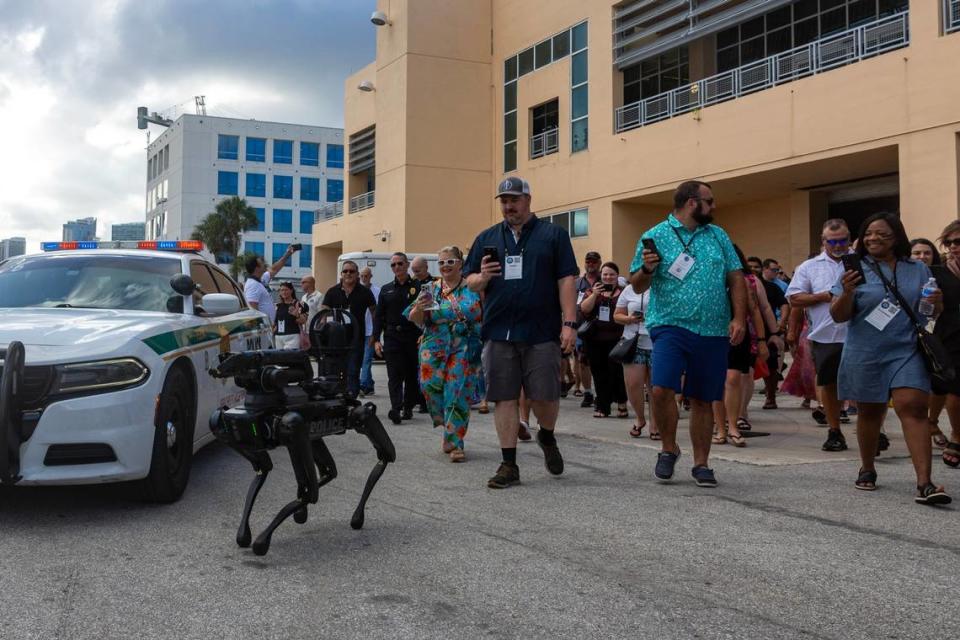 Guests followed “Spot,” a robotic dog owned by Miami-Dade Police’s Special Response Team Department to their seats during a South Florida Public Safety Regional Assets in Action Demonstration showcasing an active threat response incident in Biscayne Bay as part of the annual 2024 National Homeland Security Conference at PortMiami, Terminal J on Wednesday, July 24, 2024, in Miami, Fla.