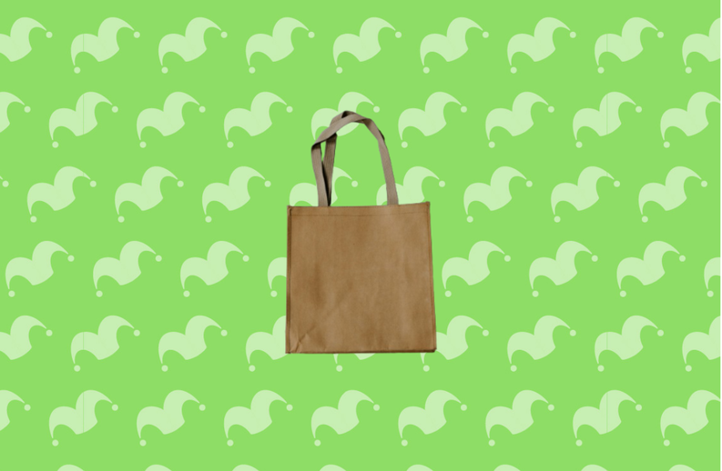 A brown reusable shopping bag against a green background