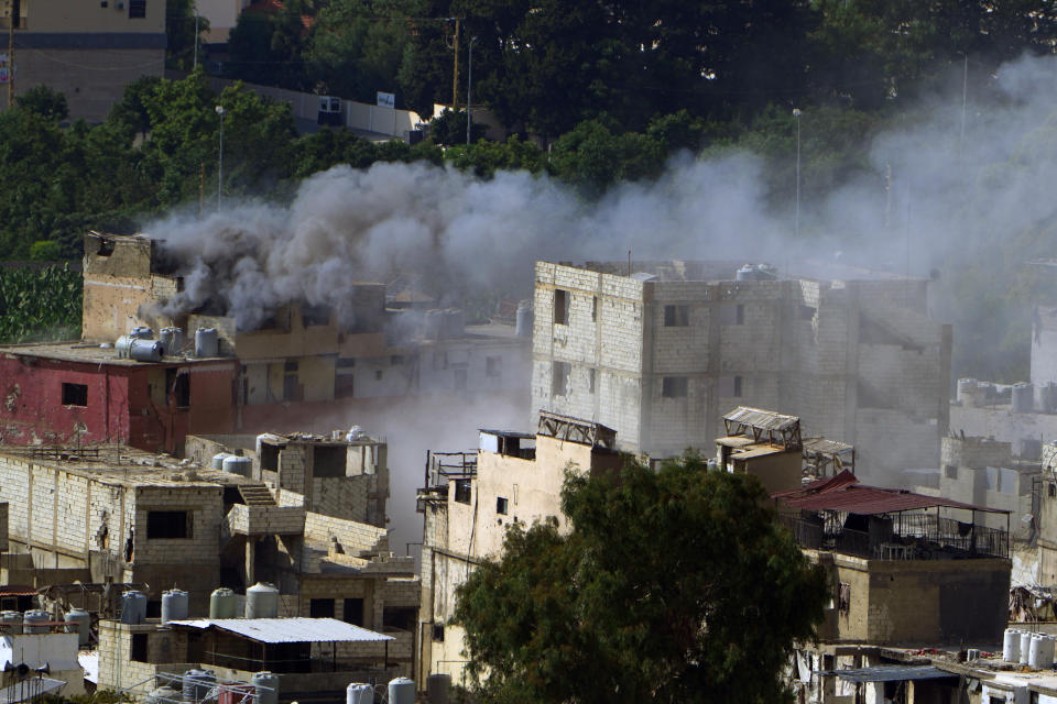 Smoke rises during clashes between members of the Palestinian Fatah group and Islamist militants in the Palestinian refugee camp of Ein el-Hilweh near the southern port city of Sidon, Lebanon, Sunday, Sept. 10, 2023. Islamist factions in Lebanon's largest Palestinian refugee camp said Sunday they will abide by a cease-fire after three days of clashes killed at least five people and left hundreds of families displaced. (AP Photo/Bilal Hussein)