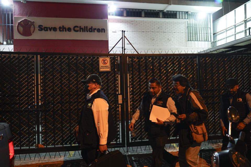 Agents from the Attorney General's office leave Save the Children's headquarters after conducting a raid of the installation, in Guatemala City, Thursday, April 25, 2024. The NGO is being investigated for an alleged complaint about the violation of migrant children's rights, according to statements made by prosecutor Rafel Curruchiche. (AP Photo/Moises Castillo)