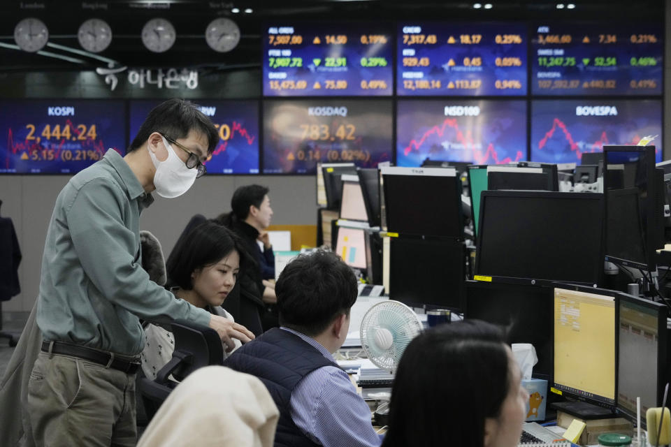 Currency traders work at the foreign exchange dealing room of the KEB Hana Bank headquarters in Seoul, South Korea, Friday, Feb. 24, 2023. Shares in Asia were mixed Friday after Wall Street broke its longest losing streak since December with a modest rally led by tech stocks. (AP Photo/Ahn Young-joon)