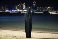 A woman stands in Katara beach, Doha, Qatar, Monday, Nov. 28, 2022. (AP Photo/Jorge Saenz)