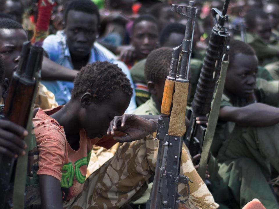 Freed child soldiers with their rifles (CHARLES LOMODONG/AFP/Getty Images)