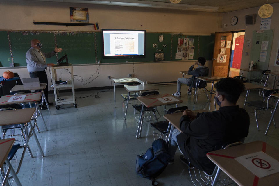 Daniel Colli teaches a 10th grade social studies class during the coronavirus outbreak at Roosevelt High School - Early College Studies, Thursday, Oct. 15, 2020, in Yonkers, N.Y. (AP Photo/Mary Altaffer)