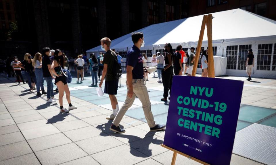 People wear masks as they wait in line at a Covid-19 testing site for returning students, faculty and staff at New York University.