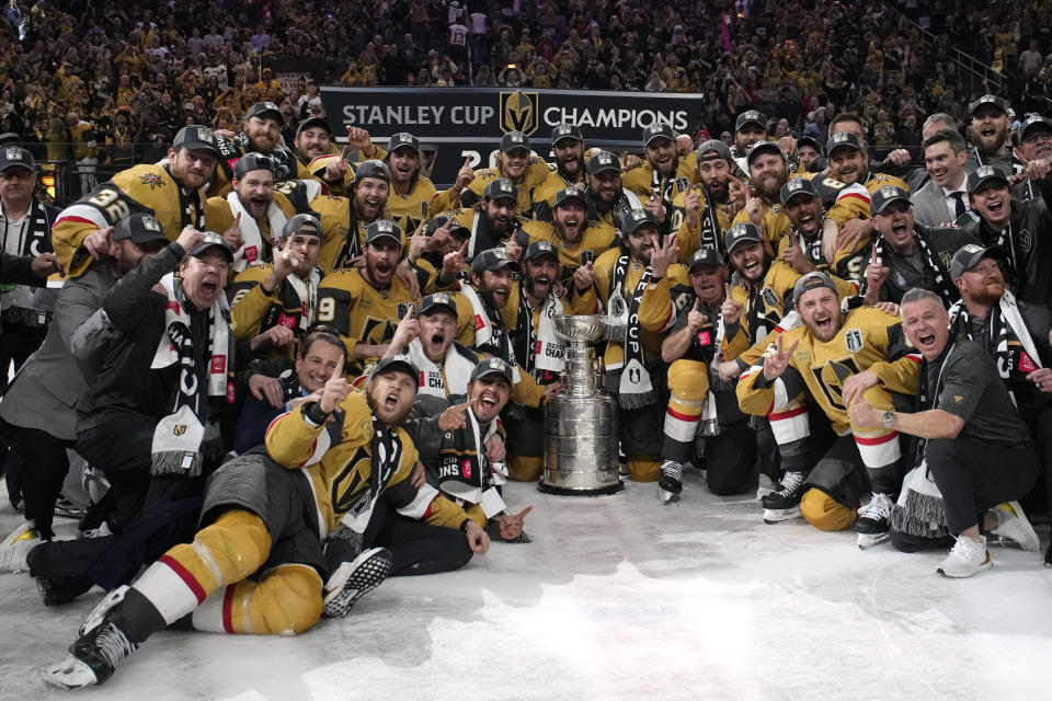 FILE - Members of the Vegas Golden Knights pose with the Stanley Cup after the Knights defeated the Florida Panthers 9-3 in Game 5 of the NHL hockey Stanley Cup Finals Tuesday, June 13, 2023, in Las Vegas. Vegas opened training camp Thursday with nearly the identical team that won the championship three months ago. (AP Photo/John Locher, File)