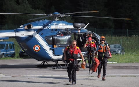 Members of the French Mountain Gendarmes (PGHM) descend form a helicopter on August 10, 2018