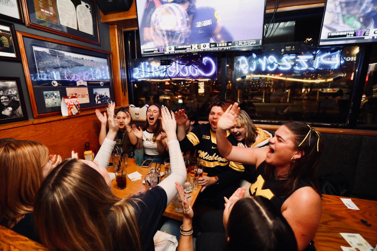 Michigan fans react to Michigan getting a first down before scoring a touchdown during the first quarter of the College Football Playoff national championship game against Washington at the Brown Jug in Ann Arbor, Mich. on Monday, Jan. 8, 2024.