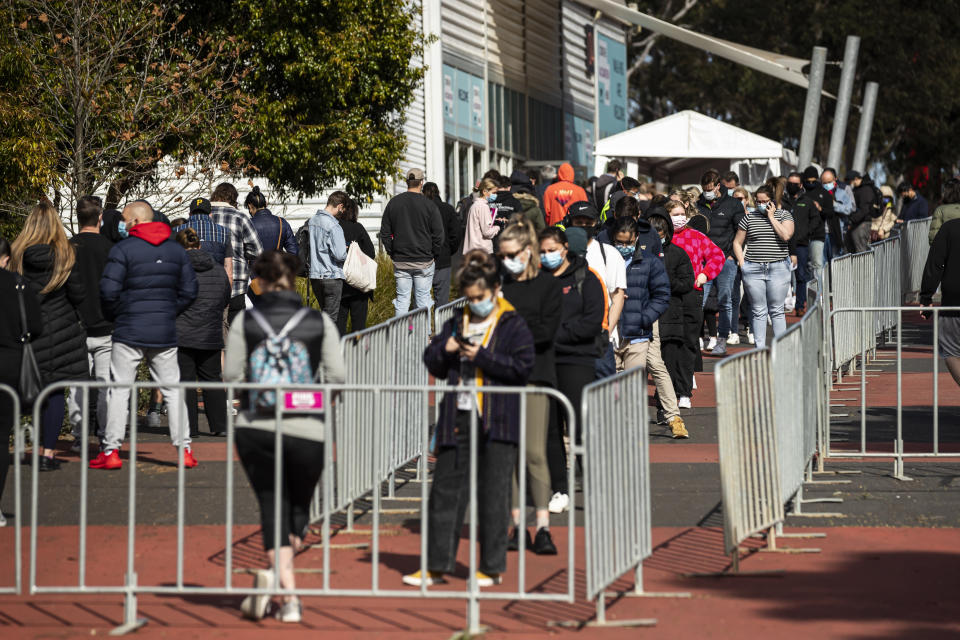 People line up outside the COVID vaccination hub at the Royal Melbourne Showgrounds in Melbourne. Source: AAP