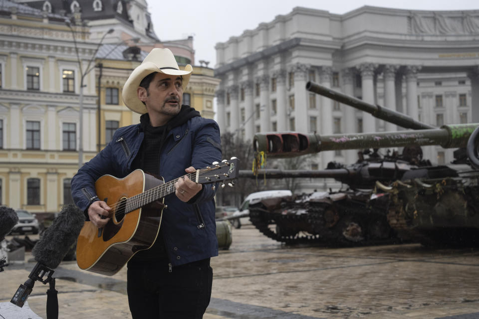 US country music singer Brad Paisley performs near damaged Russian tanks exhibition in central Kyiv, Ukraine, Wednesday, Apr. 12, 2023. (AP Photo/Efrem Lukatsky)