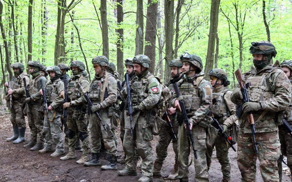 Soldiers get instructions before the start of drills at a training area in Zhytomyr region, northern Ukraine.