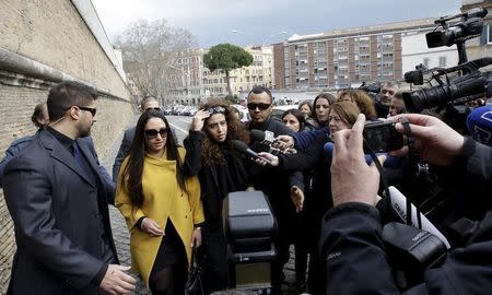 Italian laywoman Francesca Chaouqui (C) and her lawyer Laura Sgro (2nd L) arrive at the Vatican for her trial March 14, 2016. REUTERS/Alessandro Bianchi/Files