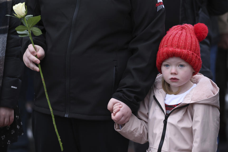 A young girl takes part in a march to commemorate the Bloody Sunday shootings in Londonderry, Sunday, Jan. 30, 2022. In 1972 British soldiers shot 28 unarmed civilians at a civil rights march, killing 13 on what is known as Bloody Sunday or the Bogside Massacre. Sunday marks the 50th anniversary of the shootings in the Bogside area of Londonderry where people will attend events to commemorate day. (AP Photo/Peter Morrison)