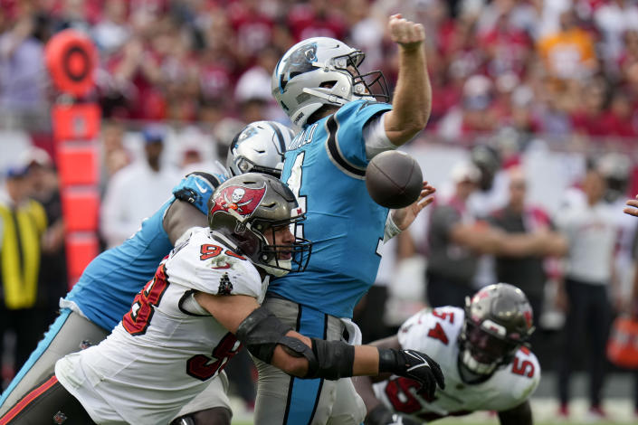 Carolina Panthers quarterback Sam Darnold is sacked by Tampa Bay Buccaneers linebacker Anthony Nelson forcing a fumble during the second half of an NFL football game between the Carolina Panthers and the Tampa Bay Buccaneers on Sunday, Jan. 1, 2023, in Tampa, Fla. (AP Photo/Chris O'Meara)