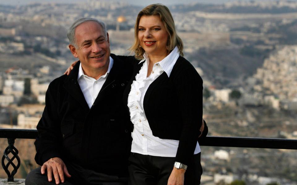 Mr Netanyahu and wife Sara during a stroll along a promenade overlooking the Old City in Jerusalem - Getty Images 