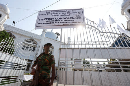 A member of the Civil Defence Force keeps watch outside Negombo Grand Mosque, following a string of suicide attacks on churches and luxury hotels, in Negombo, Sri Lanka, April 25, 2019. REUTERS/Athit Perawongmetha