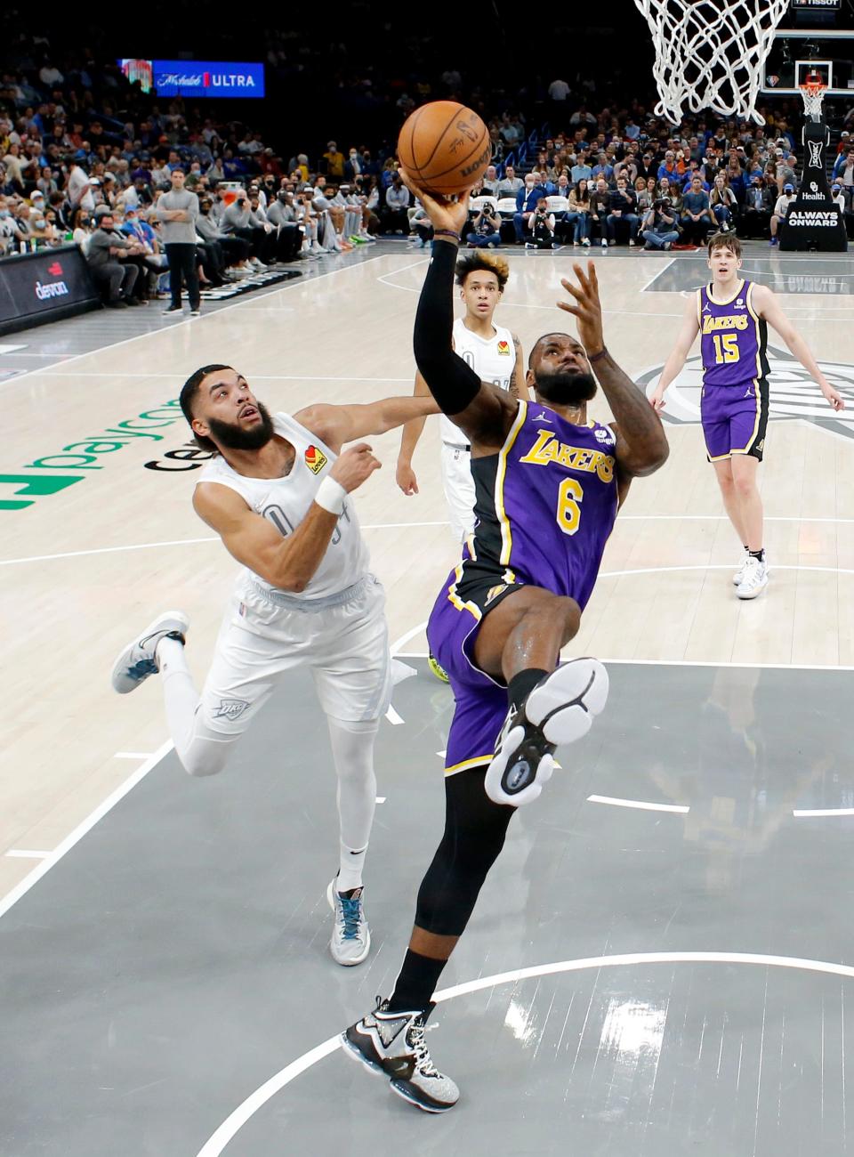 Los Angeles' LeBron James (6) goes up for a basket as Oklahoma City's Kenrich Williams (34) defends during the NBA basketball game between the Oklahoma City Thunder and the Los Angeles Lakers at the Paycom Center in Oklahoma City, Friday, Dec. 10, 2021.