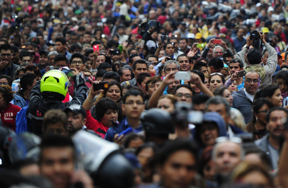 People gather outside the Palace of Fine Arts to pay tribute to Mexico's late Latin music legend Juan Gabriel, in Mexico City.