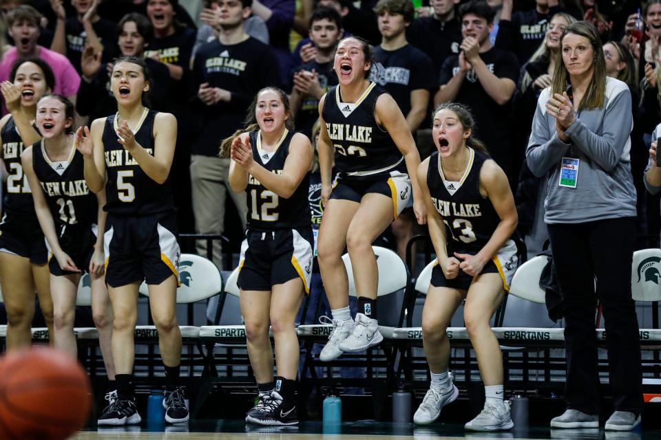 Maple City Glen Lake bench cheer for a play against Baraga during the second half of the 60-43 win over Baraga in the Division 4 girls basketball final at Breslin Center on Saturday, March 18, 2023.