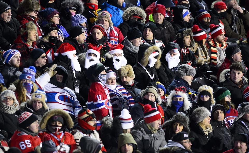 <p>Fans from both sides rock Santa Claus beards and hats while huddling together to stay warm during Ottawa’s 3-0 victory. </p>