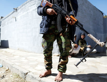 A Houthi militant secures the vicinity of United Nations offices where people demonstrated to demand for reopening of Sanaa airport in Sanaa, Yemen December 10, 2018. REUTERS/Khaled Abdullah