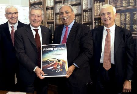 Italian engineer and designer Paolo Pininfarina (2nd L) poses with Chief Executive Officer and Managing Director of Tech Mahindra CP Gurnani (2nd R), Pininfarina CEO Silvio Angori (L) and CFO Gianfranco Albertini (R) in downtown Turin, northern Italy, December 14, 2015. REUTERS/Giorgio Perottino