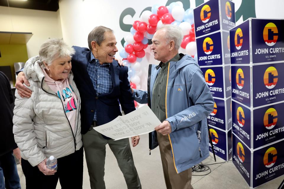 Former Rep. John Curtis, R-Utah, hugs Rose Taylor while talking to Gil Allis at a kick-off event for his U.S. Senate campaign at Saela in Orem on Monday, Jan. 22, 2024. | Kristin Murphy, Deseret News