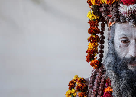 A Naga Sadhu or Hindu holy man waits for devotees inside his camp during "Kumbh Mela" or the Pitcher Festival, in Prayagraj, previously known as Allahabad, India January 17, 2019. REUTERS/Danish Siddiqui