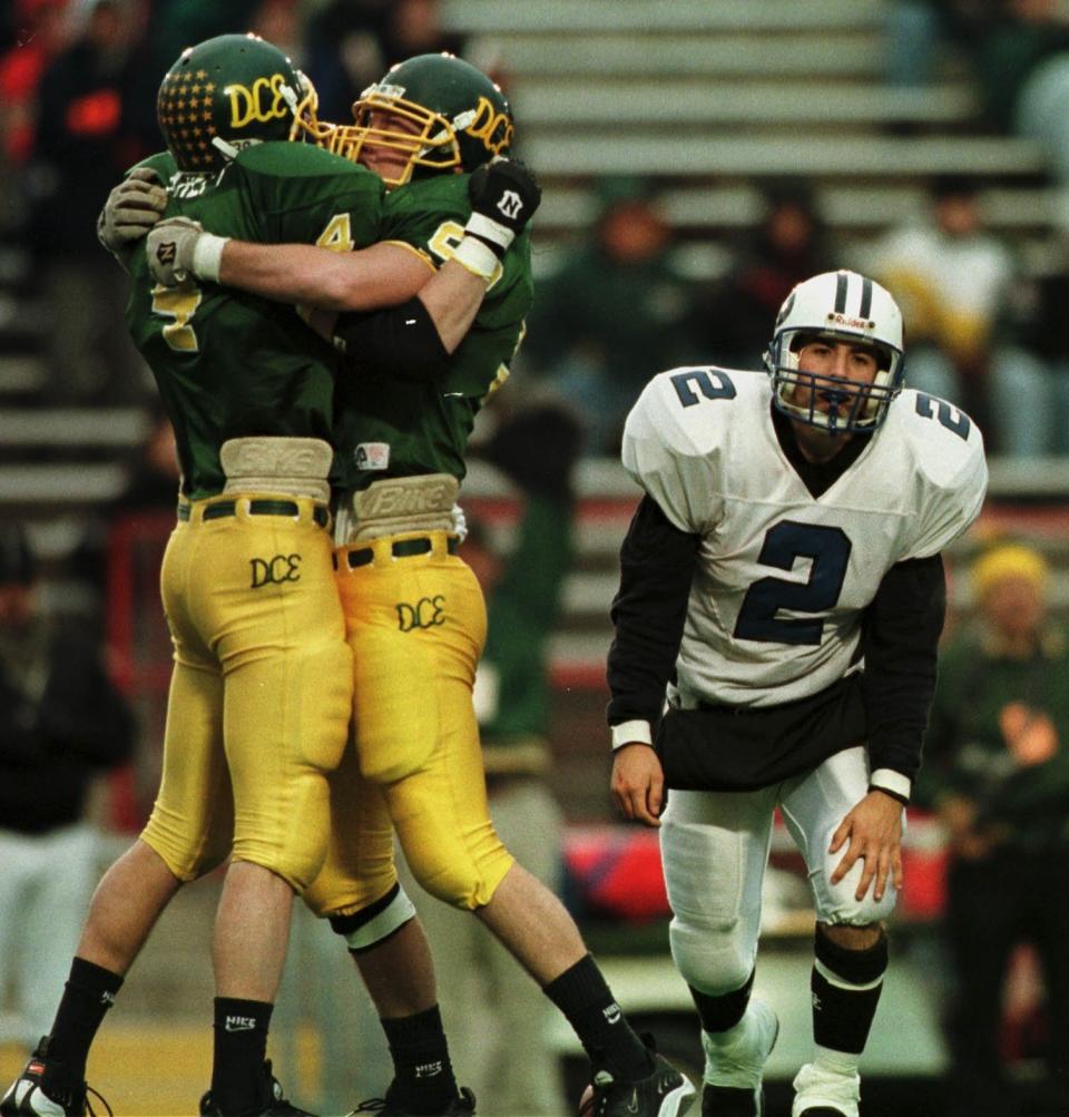 DC Everest's Tim Kreft (left) and teammate Todd Senoraske celebrate a sack by Kreft in the 4th quarter as Oak Creek's Jeremy Karls looks defeated in the 1998 Division 1 title game.