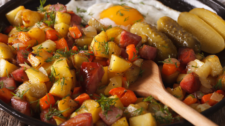 Potato hash with wooden spoon 