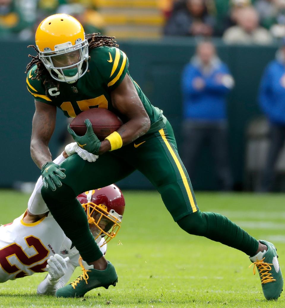 Green Bay Packers wide receiver Davante Adams (17) catches a pass in front of Washington Football Team cornerback Benjamin St-Juste (25) during their game on Sunday, Oct. 24, 2021, at Lambeau Field in Green Bay.