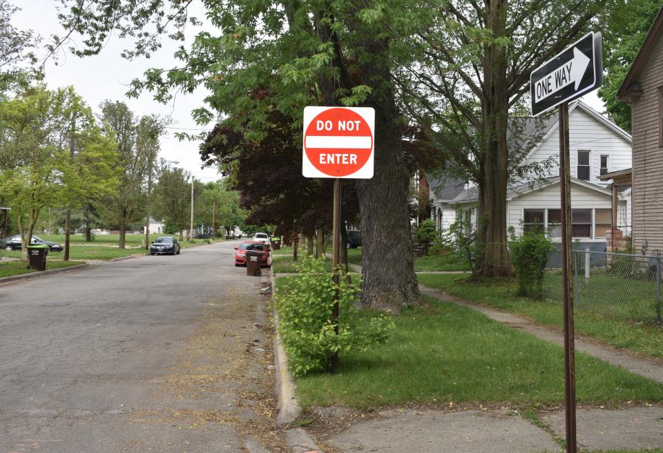 "Do Not Enter" and "One Way" signs are seen Tuesday near the intersection of Cross and South Winter streets in Adrian. The city is looking into the possibility of converting Cross Street into a two-way street.