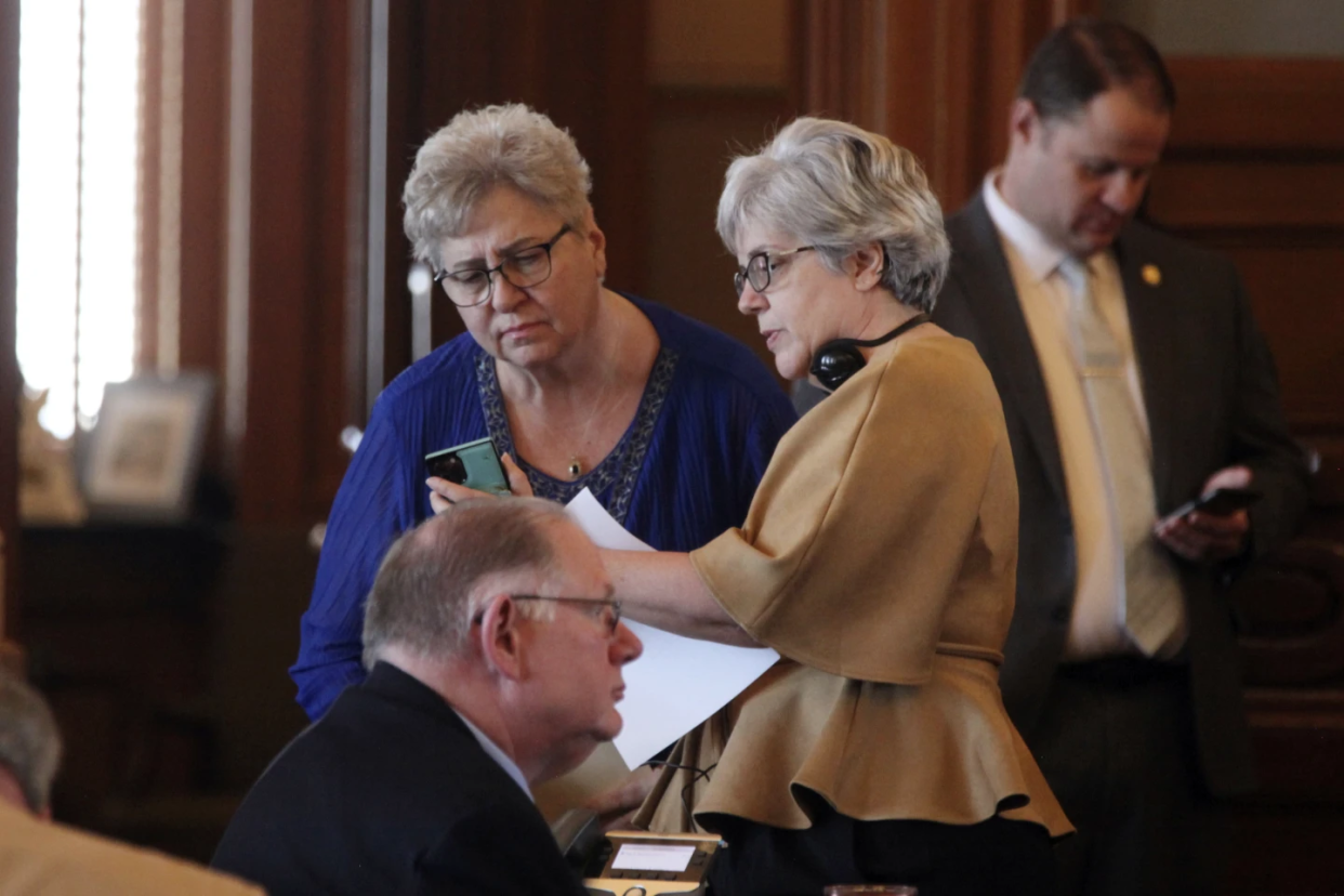 House Health and Human Services Committee Chair Rep. Brenda Landwehr, R-Wichita, left, consults with Majority Whip Susan Estes, R-Wichita, right, in front of House Speaker Dan Hawkins, R-Wichita, foreground, during a debate on abortion legislation.