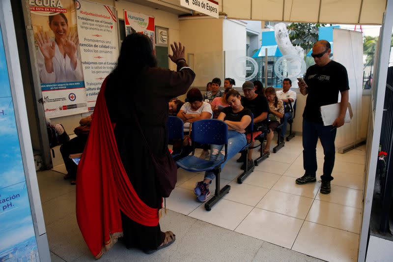 Juan Caceres, a preacher in the Christian evangelical church Israelite Mission of the New Universal Pact, proselytizes inside the waiting room of a hospital, in Lima