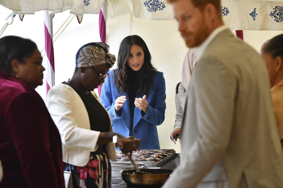 Meghan, the Duchess of Sussex, centre looks on during a reception for the women involved with the cookbook "Together" at Kensington Palace, in London, Thursday Sept. 20, 2018. The Duchess was joined by her mother Doria Ragland and husband Prince Harry for the launch of a cookbook aimed at raising money for victims of the Grenfell fire. (Ben Stansall/Pool Photo via AP)